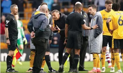  ?? Photograph: Mike Egerton/PA ?? Wolves manager Gary O'Neil (centre) speaks to referee Tony Harrington after a late goal for his side is ruled out against West Ham.