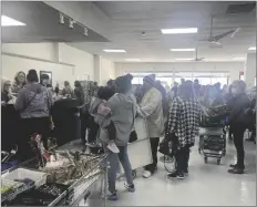  ?? ELIZABETH MAYORAL CORPUS PHOTO ?? Community members line up at cash registers to shop for a good cause during the WomanHaven Thrift Store re-opening event on Thursday, February 2, in El Centro.