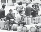  ?? PHOTO: REUTERS ?? People wait in line to buy gas cylinders at a distributi­on place after the arrival of the gas trucks, amid the country’s economic crisis in Colombo, in Sri Lanka