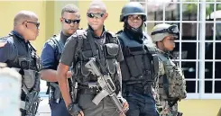  ?? FILE ?? Members of the security forces on a murder scene in the March Pen community of Spanish Town, St Catherine, on October 10.