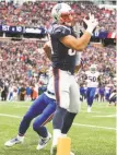  ?? Tim Bradbury / Getty Images ?? Rob Gronkowski hauls in a touchdown pass against Buffalo in the second quarter.