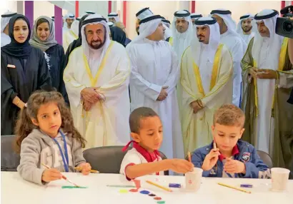  ??  ?? Dr Sheikh Sultan bin Mohammed Al Qasimi watches children engaged in activities as he tours the pavilions of the reading festival. He visited a number of local, Arab and internatio­nal publishing houses, as well as the stalls of several cultural and...