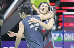  ??  ?? Takeshi Kamura and Keigo Sonoda celebrate winning the men’s doubles title.