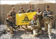  ??  ?? Members of the 1st Platoon, James O. Twist (left), Reyler Leon, Joe Morrissey, Andy Lehrer, Mike McGuinness, Dallas Haggard (right, kneeling) and Brandon Krebs pose with a flag in Afghanista­n in 2012.