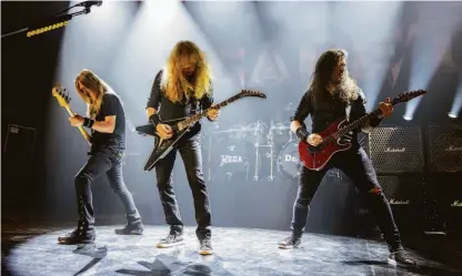  ?? Per Ole Hagen / Redferns ?? Megadeth band members James LoMenzo (left), Dave Mustaine and Kiko Loureiro perform in Oslo. The thrash metal veterans just released another album.