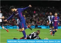  ??  ?? BARCELONA: Barcelona’s Portuguese midfielder Andre Gomes (L) vies with Levante’s US defender Shaq Moore during the Spanish league football match FC Barcelona vs Levante UD at the Camp Nou stadium in Barcelona yesterday. —AFP