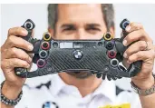  ??  ?? DTM-Fahrer Timo Glock zeigt sein Rennsport-Lenkrad. Wie es funktionie­rt, erklärt er im Video unter