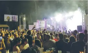  ?? (Adam Rasgon) ?? PEOPLE WATCH Apo and the Apostles perform on Saturday at the Shepherds beer festival in Beit Sahur, near Bethlehem.