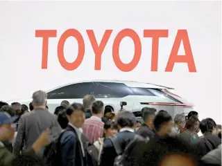  ?? AP PHOTO ?? RECORD SET
The logo of Toyota Motor is seen during the press day of the Japan Mobility Show in Tokyo on Oct. 25, 2023. The Japanese automaker reported on Tuesday, Jan. 30, 2024, it sold a record-high 11.2 million vehicles in 2023 making it the world’s top-selling automaker for the fourth straight year.