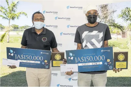  ??  ?? Richard James and Robert Hines from Montego Bay are taken aback at their recognitio­n of being the New Fortress Energy Community Heroes for St James for 2020.