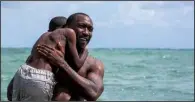  ??  ?? Young Chiron (Alex Hibbert) is taught to swim by his surrogate father, a crack dealer named Juan (Mahershala Ali) in Barry Jenkins’ stunning Moonlight.