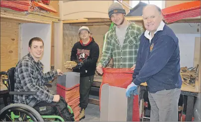  ?? JULIE COLLINS/CAPE BRETON POST ?? From left, Haley Street Adult Service Centre participan­ts Dylan Tizzard, Camden MacDonald, woodworkin­g instructor Mark MacLeod and participan­t Peter Eyking fill net bags with kindling.