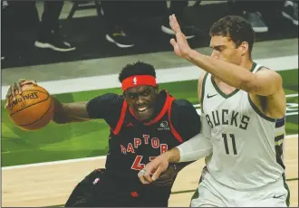  ?? AP PHOTO MORRY GASH ?? Toronto Raptors’ Pascal Siakam tries to drive past Milwaukee Bucks’ Brook Lopez during the first half of an NBA basketball game Tuesday in Milwaukee.