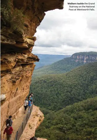  ??  ?? Walkers tackle the Grand Stairway on the National Pass at Wentworth Falls.