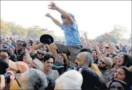  ?? Gary Coronado Los Angeles Times ?? A FAN crowd surfs during Iggy Pop’s performanc­e at FYF Fest last summer.