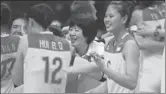  ?? XINHUA ?? Lang Ping (center), coach of China’s women’s volleyball team, celebrates with her team members after the team won gold at the Rio de Janeiro Olympics on Sunday.