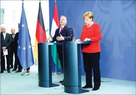  ?? OMER MESSINGER/AFP ?? German Chancellor Angela Merkel (right) and Hungarian Prime Minister Viktor Orban give a joint press conference following a meeting on Thursday in Berlin.