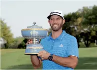  ?? AP ?? Dustin Johnson poses with his trophy after defeating Jon Rahm, of Spain, at the Dell Technologi­es Match Play tournament. —