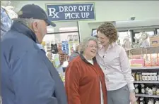  ??  ?? Stephanie Smith Cooney, right, pharmacist at Gatti Pharmacy in Indiana, Pa. greets customer Luida Shearer as Luida’s husband, Ron, looks on.