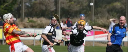  ??  ?? Rapparees centre-back Ricky Fox clears his lines under pressure from Fethard’s Mark Wallace.