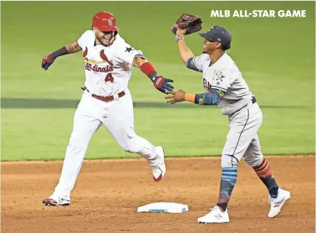  ?? KIM KLEMENT, USA TODAY SPORTS ?? The NL’s Yadier Molina, left, jokes with AL shortstop Francisco Lindor while rounding the bases Tuesday after his homer in the sixth inning of the All-Star Game in Miami. The game ended too late for this edition. For coverage, go to mlb.usatoday.com.