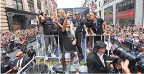  ??  ?? United States midfielder Julie Ertz takes a selfie with teammates during a ticker-tape parade to celebrate the Americans’ Women’s World Cup championsh­ip Wednesday in New York. ROBERT DEUTSCH/USA TODAY SPORTS