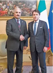  ?? (AFP) ?? Italy’s Prime Minister Giuseppe Conte (right) shakes hands with Libya’s military strongman Khalifa Haftar in Rome on Wednesday