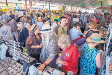  ?? EDDIE MOORE/JOURNAL ?? Thousands of people shop through the booths at the 15th annual Internatio­nal Folk Art Market in Santa Fe last July. The state’s tourism industry had a $6.6 billion impact on the New Mexico economy in 2017.