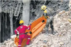  ?? AP ?? Rescuers carry a stretcher at the site of the deadly explosion that destroyed the five-star Hotel Saratoga, in Havana, Cuba.