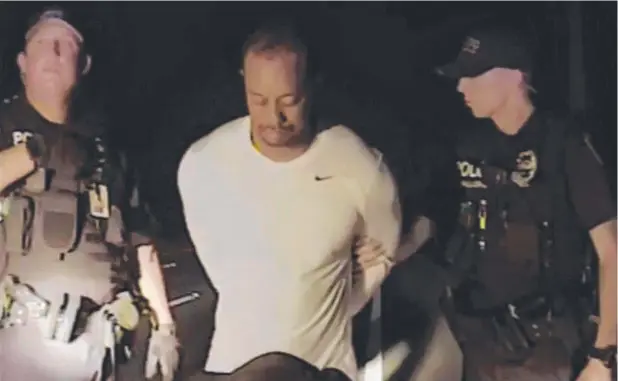  ??  ?? Dashcam footage of Tiger Woods’ DUI arrest. The profession­al golfer was found slumped at the wheel of his car near his home in Florida earlier this week.