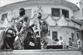  ?? Carolyn Cole Los Angeles Times ?? SOLDIERS patrol a street in San Salvador. A mass deportatio­n from the U.S. could worsen conditions in El Salvador, as happened in the 1990s, critics say.