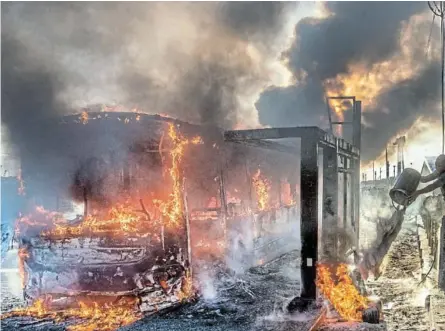  ?? /GALLO IMAGES/BRENTON GEACH ?? A MyCiti bus burns in Khayelitsh­a during a taxi strike and transport shutdown in Cape Town when pupils could not get to school to write their matric exams.