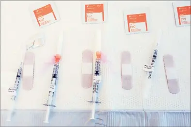  ?? Ned Gerard / Hearst Connecticu­t Media ?? Syringes filled with COVID-19 vaccine wait on a table at Hartford HealthCare’s new mass vaccinatio­n clinic on the west campus of Sacred Heart University in Fairfield on March 10.