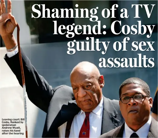  ??  ?? Leaving court: Bill Cosby, flanked by spokesman Andrew Wyatt, raises his hand after the hearing