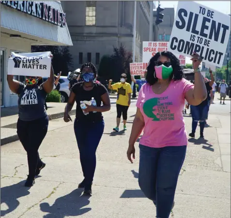  ?? (The Record via AP/Ruby Thomas) ?? Black Catholics walk from the federal courthouse building in downtown Louisville, Ky., to 12th and Broadway, in the “Black Catholics Unite: Stand For Justice March” June 6 which was organized by young adults. Black Catholics across the U.S. hear their church’s leaders once again calling for racial justice, but at this volatile moment, they want action as well as words.