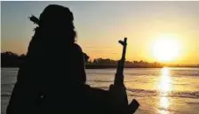  ?? AP ?? ‘Caliphate’s New York’ A Daesh fighter relaxes on the bank of the Euphrates river in Raqqa, Syria. Raqqa is now the ‘new New York’ of the ‘caliphate’ the group is trying to set up.