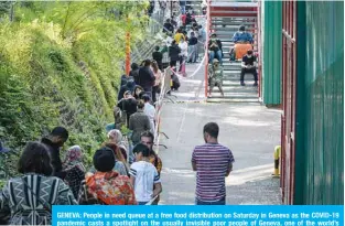  ??  ?? GENEVA: People in need queue at a free food distributi­on on Saturday in Geneva as the COVID-19 pandemic casts a spotlight on the usually invisible poor people of Geneva, one of the world’s most expensive cities. —AFP