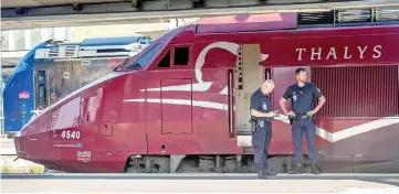  ??  ?? This file photo shows French police standing guard along the platform next to a Thalys train of French national railway operator SNCF at the main train station in Arras, northern France. — AFP photo