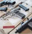  ?? CHRIS YOUNG THE CANADIAN PRESS ?? Toronto police display guns seized during a series of raids.