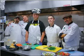  ?? Signal file photo ?? Master chef Luca Luca Toumadi, right, pictured recently with staff and interns in the kitchen at Bella Cucina in Seco Canyon Village, had to lay off nearly his entire staff following the Los Angeles County order Monday temporaril­y halting eat-in dining.