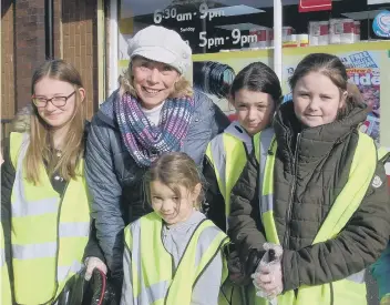  ??  ?? Coun Gillian Galbraith with some of the members from the Youth Almighty Club who helped litter pick.