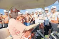  ?? PHELAN M. EBENHACK/ORLANDO SENTINEL ?? Boone coach Andy Johnson, who is undergoing cancer treatment for Hodgkin’s lymphoma, talks to the team from his cart Monday.