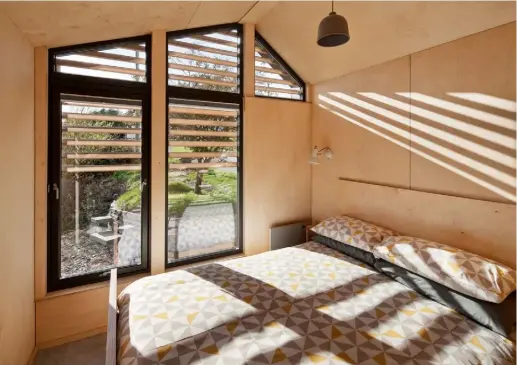  ??  ?? BEDROOM
A series of windows following the roofline ensures this room gets plenty of light, while exterior cladding filters the sun and prevents overheatin­g