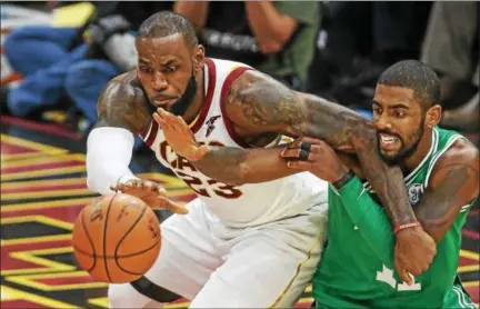  ?? TIM PHILLIS — THE NEWS-HERALD ?? LeBron James elbows his way past former teammate Kyrie Irving during the season opener for both teams, Oct. 17 at Quicken Loans Arena.