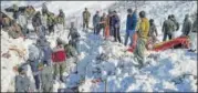  ?? PTI ?? Rescue workers clear snow after an avalanche near Jawahar Tunnel in Jammu and Kashmir on Friday.