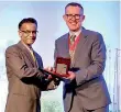  ??  ?? Suren Rajakarier receiving the award from Immediate Past President of ACCA Global, Brian Mcenery