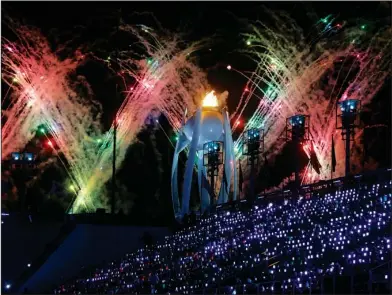  ?? The Associated Press ?? CLOSING CEREMONY: Fireworks explode over the Olympic flame during the closing ceremony of the 2018 Winter Olympics on Sunday in Pyeongchan­g, South Korea.