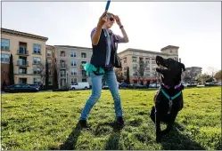  ?? RANDY VAZQUEZ – STAFF ARCHIVES ?? Verena Niemeier, left, plays with her dog Milos, right, at River Oak Park near Crescent Village in San Jose on Jan. 30. The apartment complex is the largest built in the U.S. in the last decade.