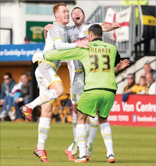  ??  ?? ED IN THE CLOUDS: Burton Albion’s Phil Edwards, second right, celebrates after scoring their second goal