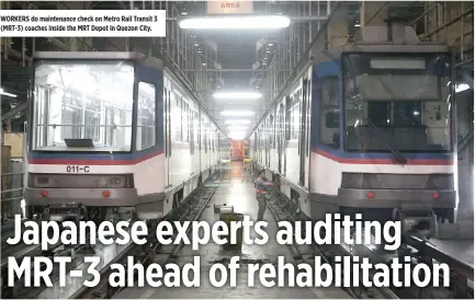  ??  ?? WORKERS do maintenanc­e check on Metro Rail Transit 3 (MRT-3) coaches inside the MRT Depot in Quezon City.